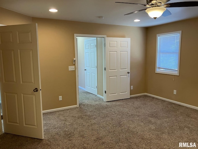 unfurnished bedroom with ceiling fan and carpet