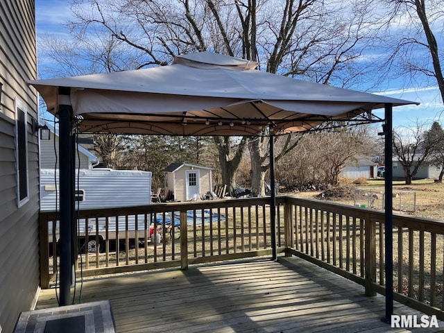 deck with a gazebo and a storage unit