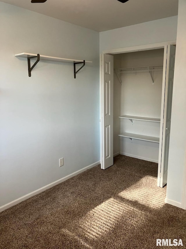 unfurnished bedroom with a closet and carpet flooring