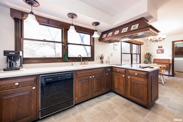 kitchen featuring decorative light fixtures, black appliances, premium range hood, sink, and light tile flooring