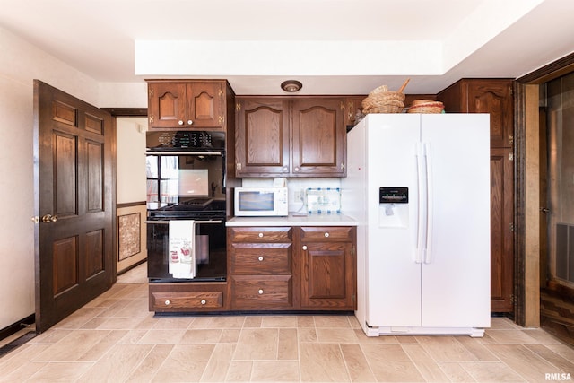 kitchen with white appliances and light tile flooring