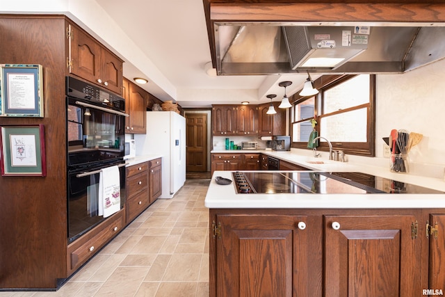 kitchen featuring light tile floors, black appliances, sink, wall chimney exhaust hood, and hanging light fixtures