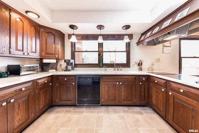 kitchen featuring black appliances, decorative light fixtures, a tray ceiling, and light tile flooring