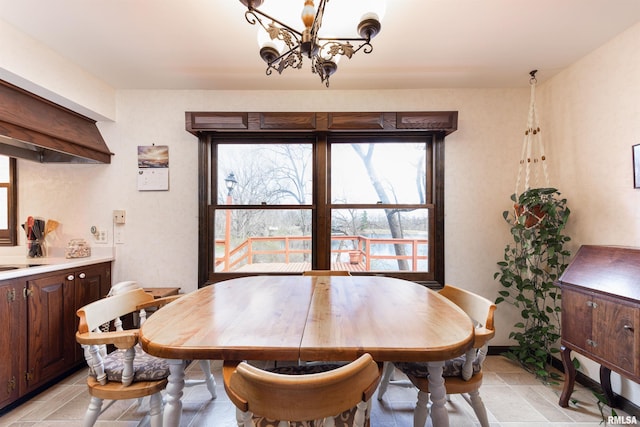 tiled dining area with a notable chandelier