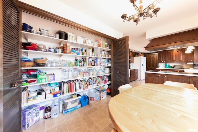 interior space featuring light tile floors and a chandelier