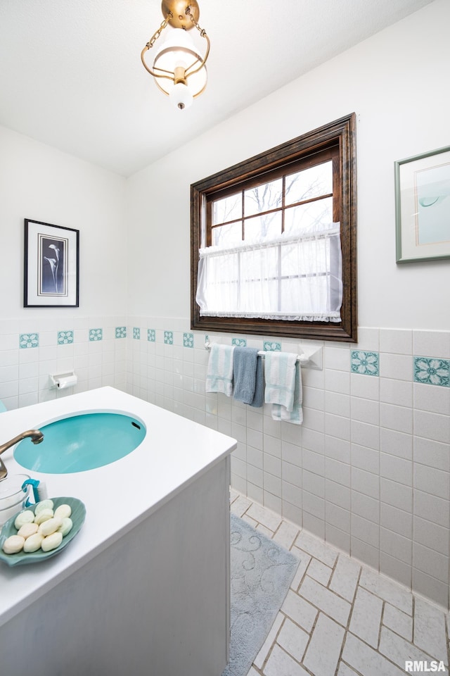 bathroom with tile floors, tile walls, and vanity