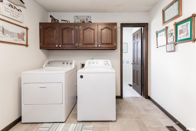 laundry area with independent washer and dryer, cabinets, light tile floors, and hookup for a washing machine