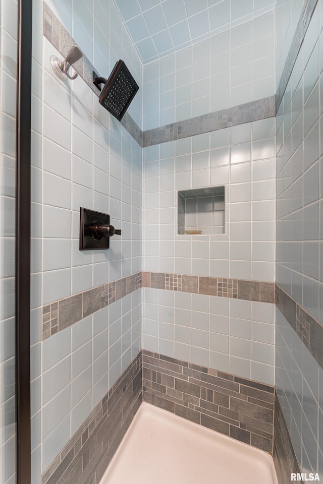 bathroom with tiled shower