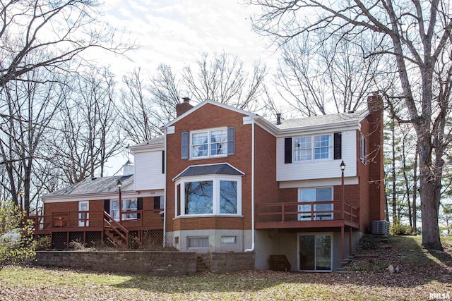 rear view of house with central air condition unit and a deck