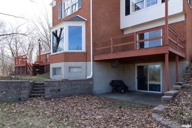 rear view of property featuring a wooden deck