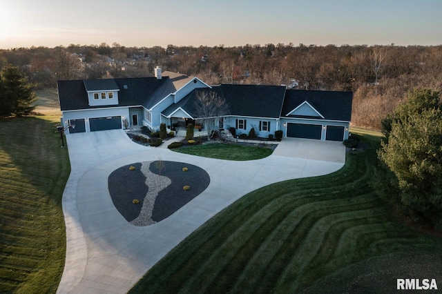 view of front facade featuring a garage and a lawn