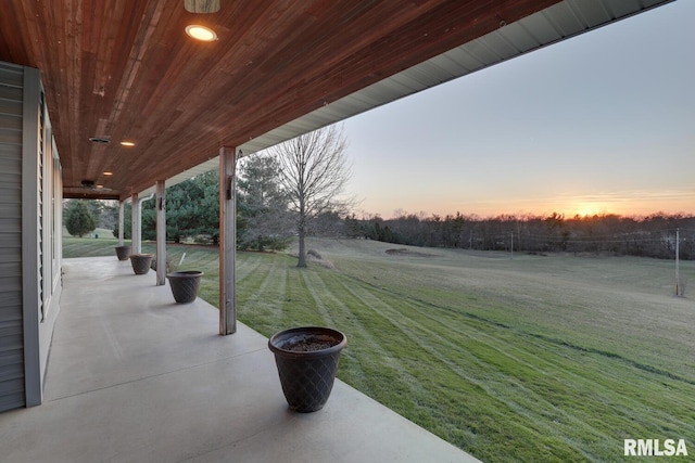 yard at dusk with a patio area