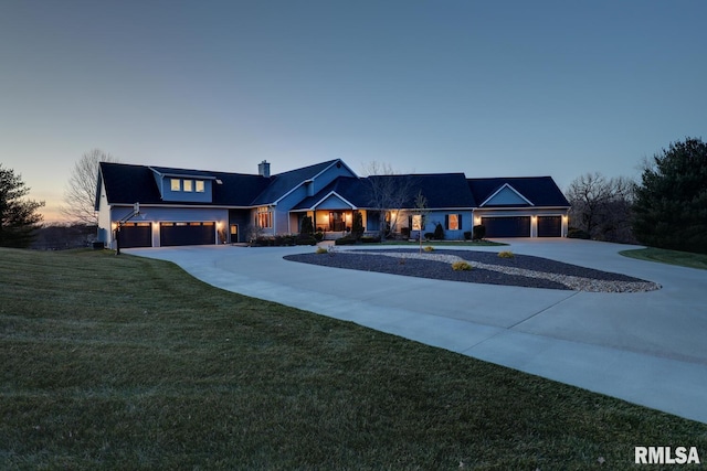 view of front of home with a garage and a yard