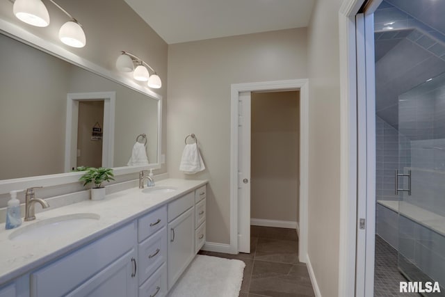 bathroom with vanity, a shower with shower door, and tile patterned floors