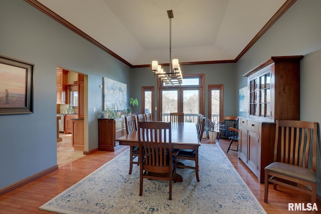 dining room with a notable chandelier, light hardwood / wood-style floors, and ornamental molding