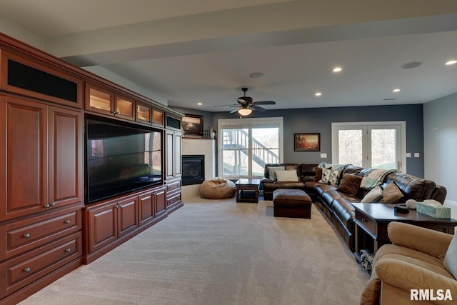 carpeted living room with ceiling fan