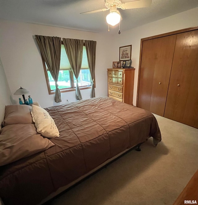 carpeted bedroom featuring a closet and ceiling fan