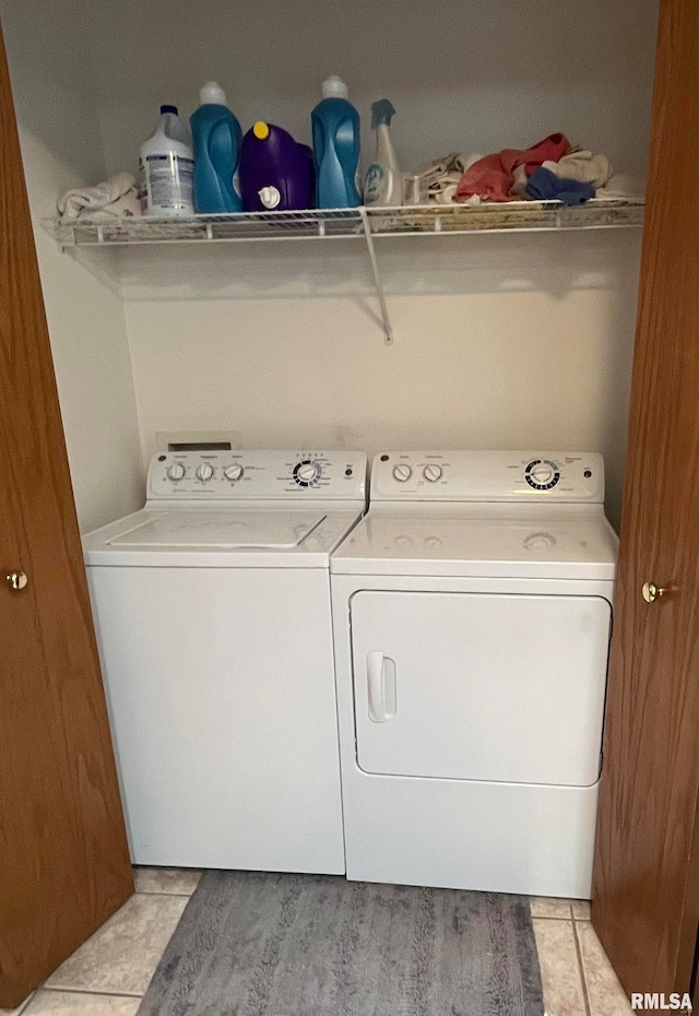 washroom with light tile flooring and washing machine and clothes dryer