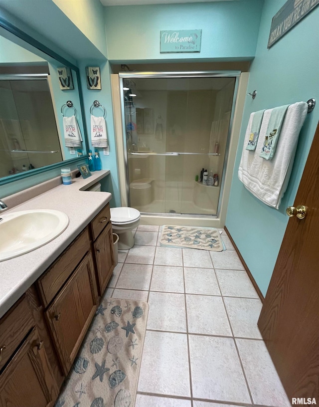 bathroom with large vanity, an enclosed shower, tile floors, and toilet