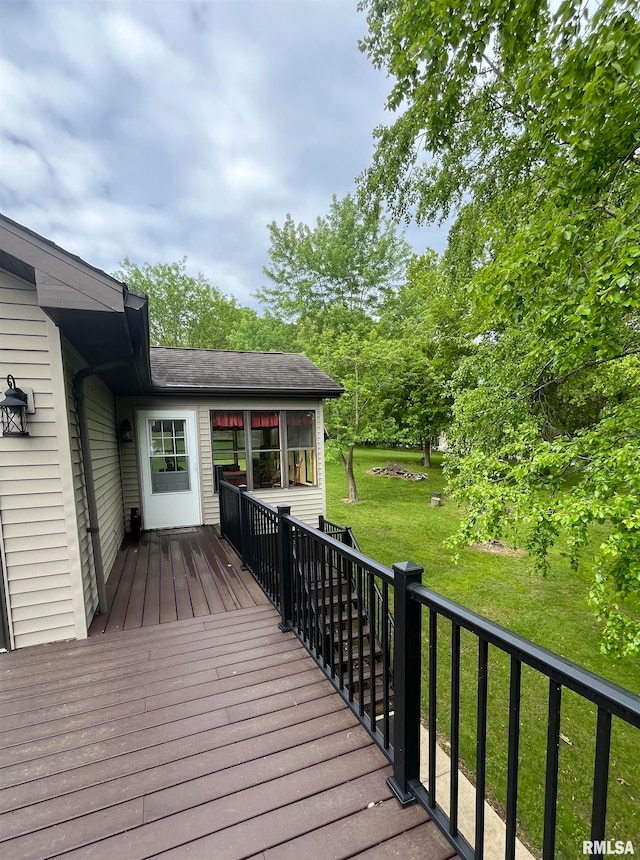 wooden deck featuring a yard