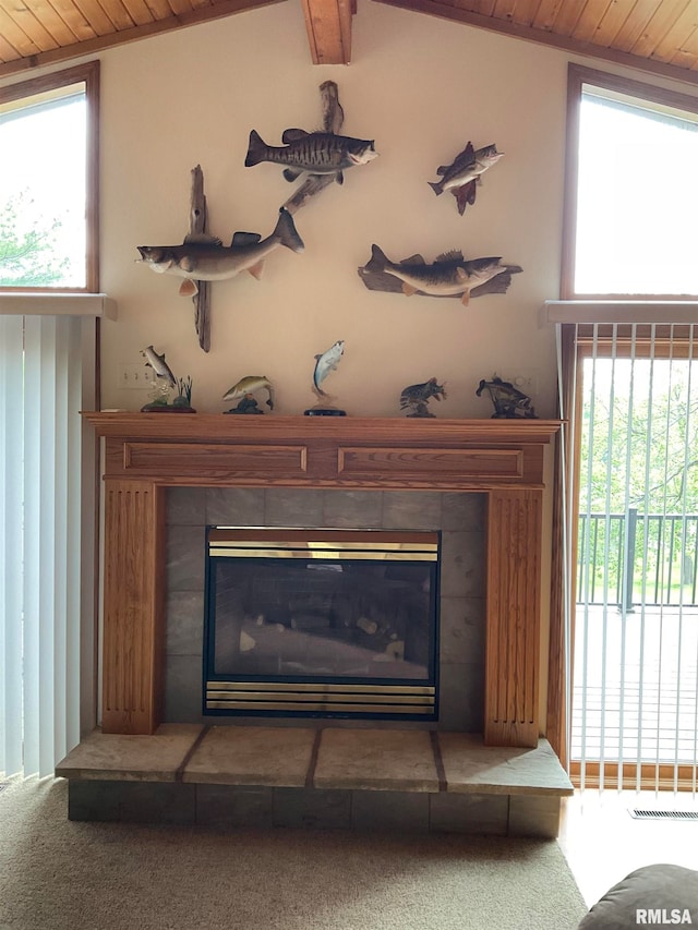 room details featuring carpet flooring, a tiled fireplace, and wooden ceiling