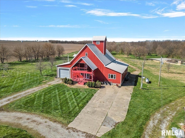 exterior space featuring a yard and a rural view