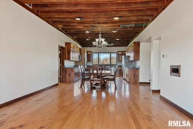 unfurnished dining area featuring a chandelier and light hardwood / wood-style floors