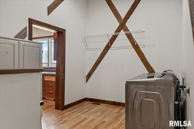 laundry room with light wood-type flooring