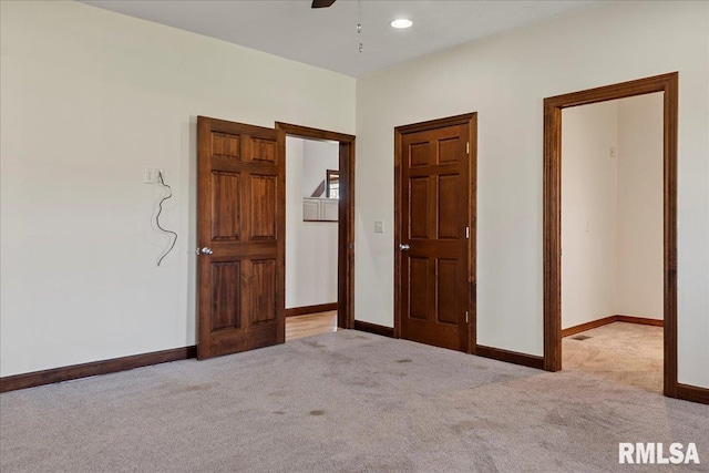 unfurnished bedroom with light colored carpet and ceiling fan