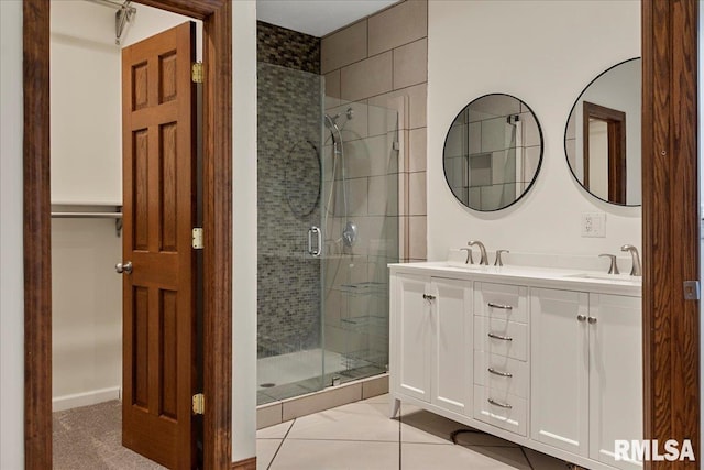 bathroom with tile patterned flooring, an enclosed shower, and vanity