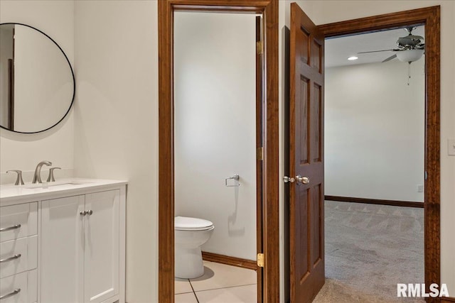 bathroom featuring toilet, ceiling fan, and vanity