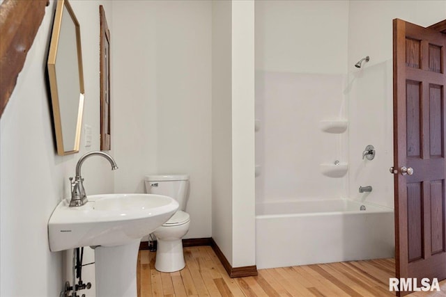 bathroom featuring hardwood / wood-style floors, toilet, and shower / bath combination