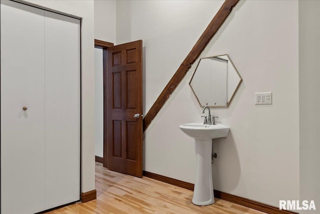 bathroom with hardwood / wood-style flooring