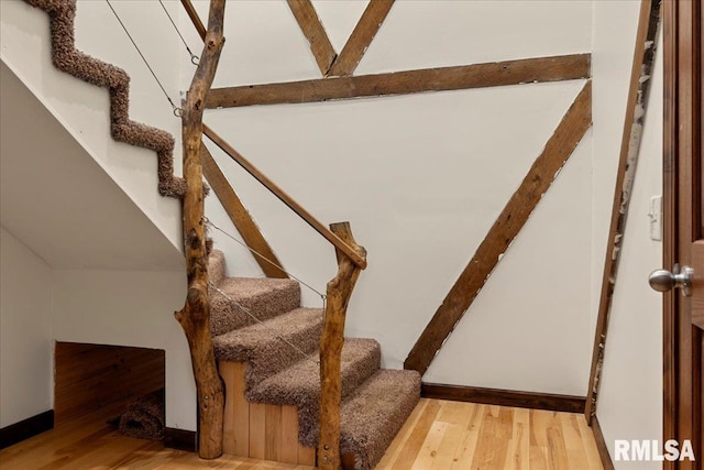 staircase featuring wood-type flooring