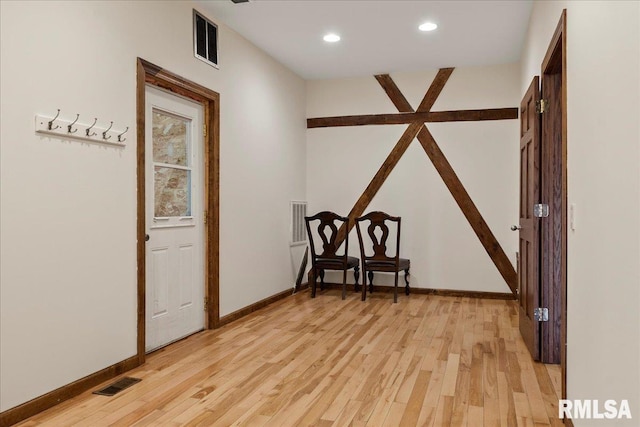 hallway with light hardwood / wood-style flooring