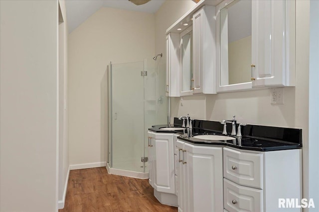 bathroom featuring walk in shower, hardwood / wood-style floors, and vanity