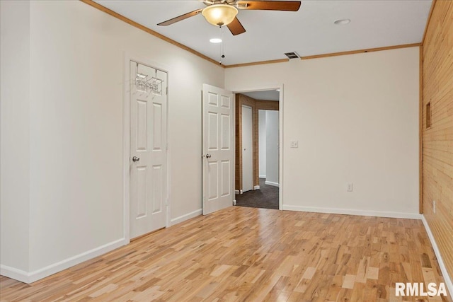 unfurnished room with crown molding, ceiling fan, and light hardwood / wood-style flooring