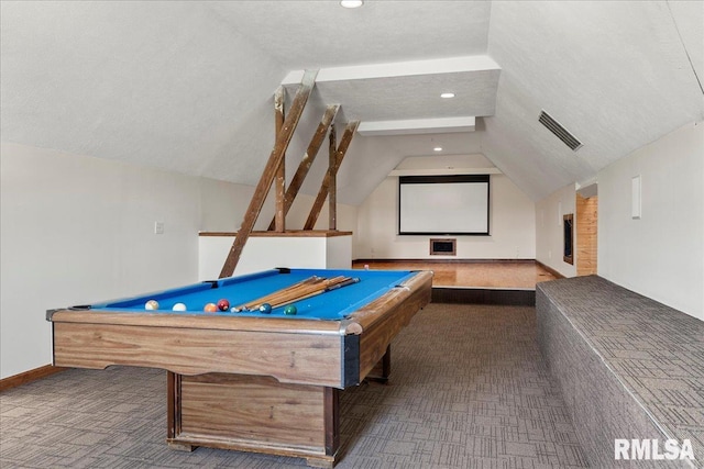 game room with pool table, lofted ceiling, a textured ceiling, and dark carpet