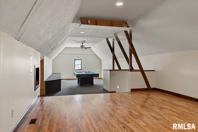 interior space with pool table, hardwood / wood-style flooring, a textured ceiling, lofted ceiling, and ceiling fan