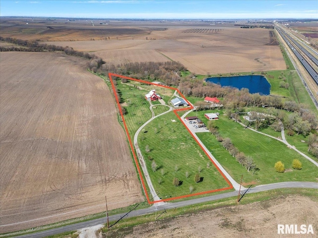 birds eye view of property featuring a water view and a rural view