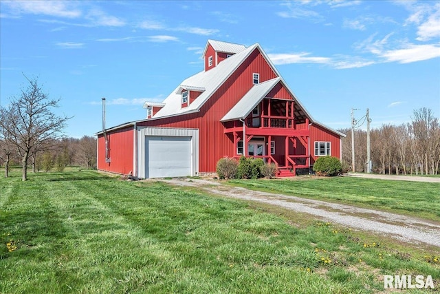 view of front facade with a garage, an outdoor structure, and a front lawn