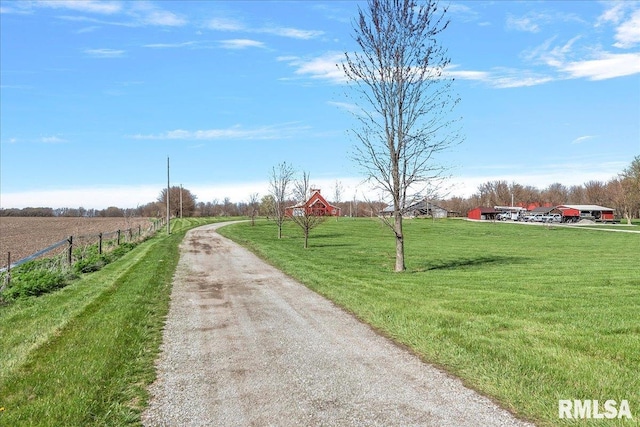 surrounding community featuring a lawn and a rural view