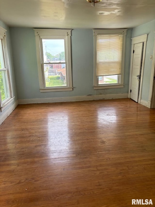 unfurnished room featuring hardwood / wood-style flooring