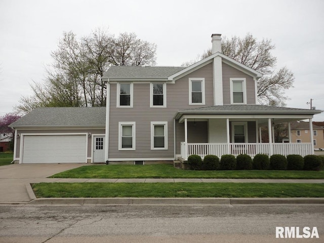 view of front of house with covered porch, a garage, and a front yard