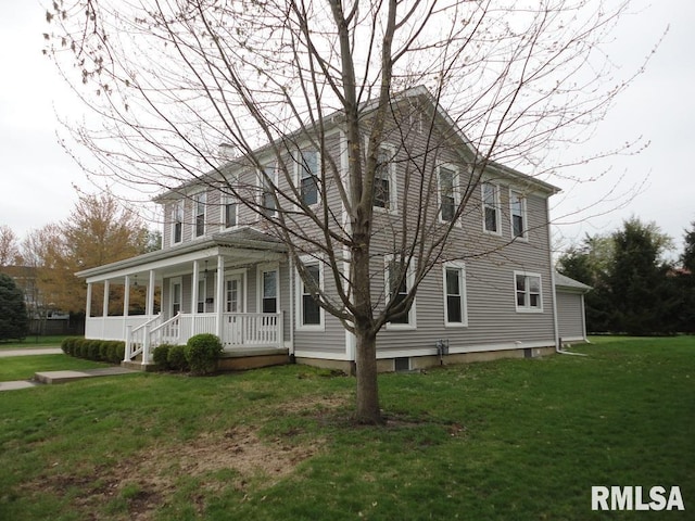 colonial home featuring a front lawn and a porch