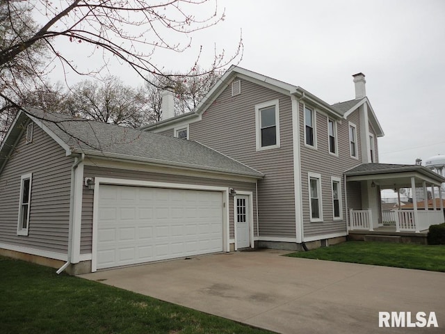 view of front of property with a garage, a porch, and a front lawn