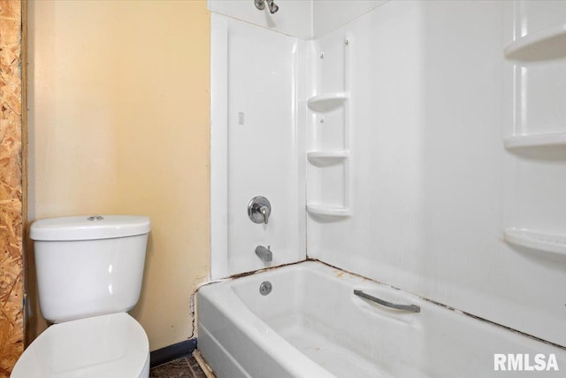 bathroom with washtub / shower combination and toilet