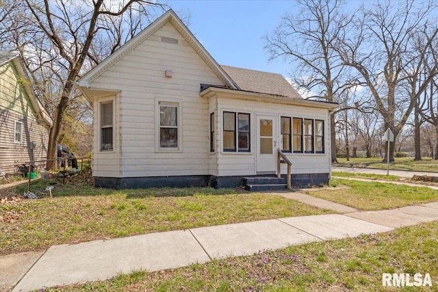 bungalow-style house with a front yard