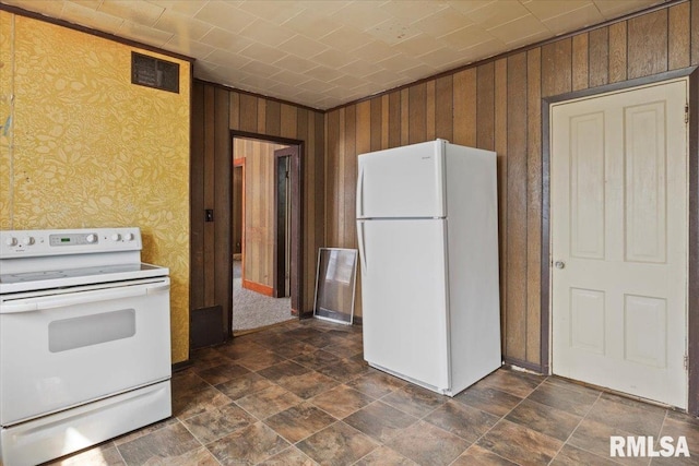 kitchen with white appliances and wooden walls