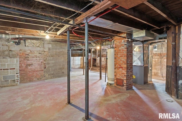 basement featuring heating unit and gas water heater